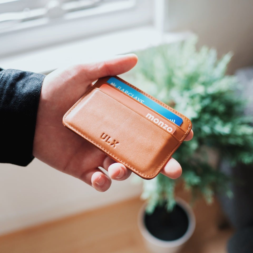 Hand holding a card wallet with loyalty cards